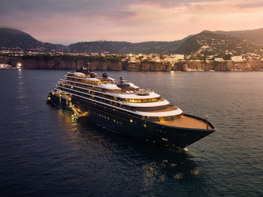 Ritz-Carlton Yacht Collection Evrima at anchor at dusk off the Amalfi coast