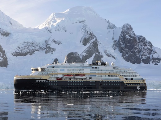 Hurtigruten MS Fridtjof Nansen before a towering Antarctic glacier